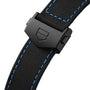 Close-up of a black fabric strap with blue stitching and matte black clasp bearing TAG Heuers shield logo, inspired by Monza motorsports and crafted for the Monza Flyback Chronometer’s COSC-certified precision.