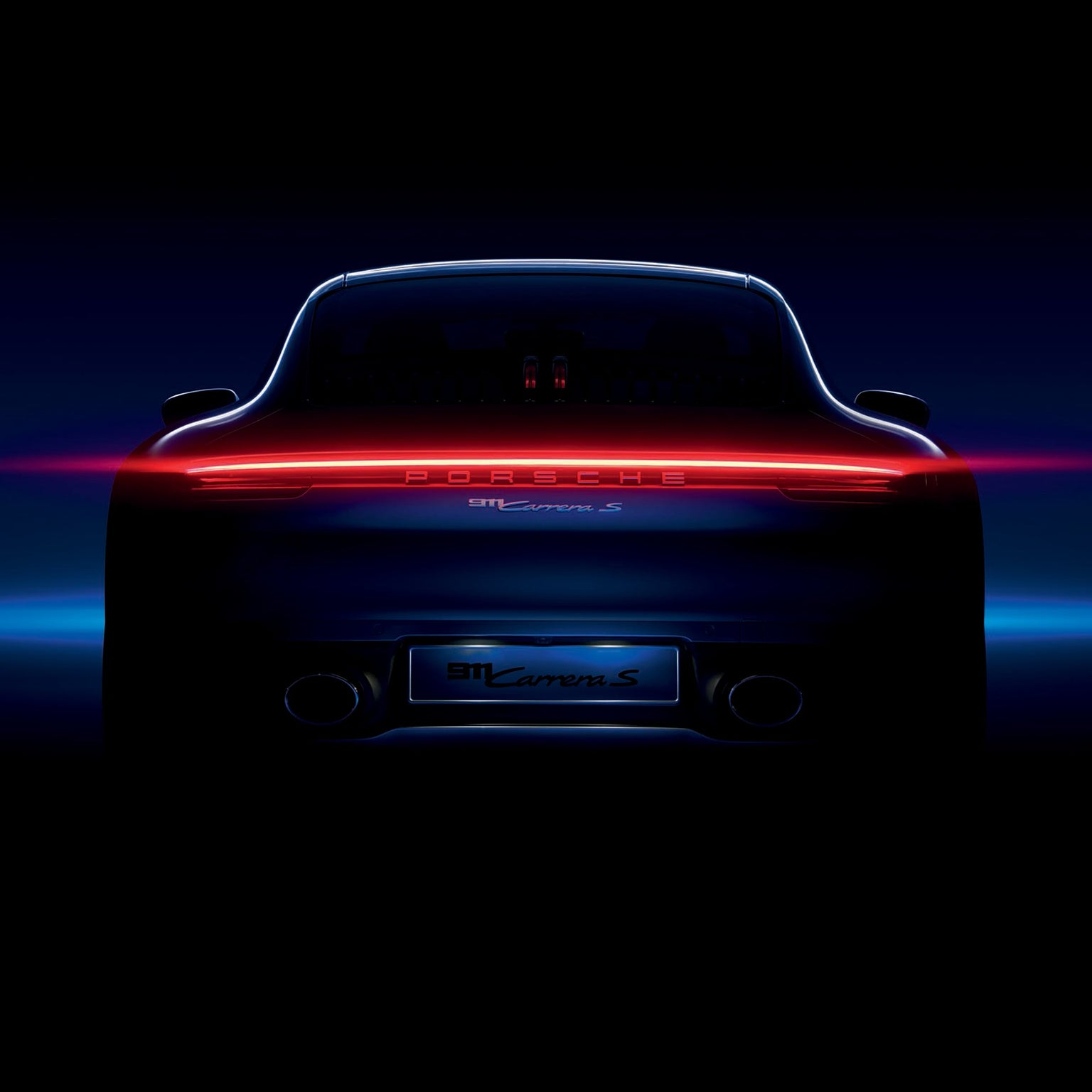 Rear view of a Porsche 911 Carrera S with glowing taillights, set against a dark background—a striking tribute to the legacy behind the TAG Heuer Special Edition Carrera Chronograph x Porsche.