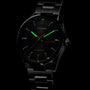 A TAG Heuer Carrera Day-Date watch featuring luminous markers that glow green in the dark.