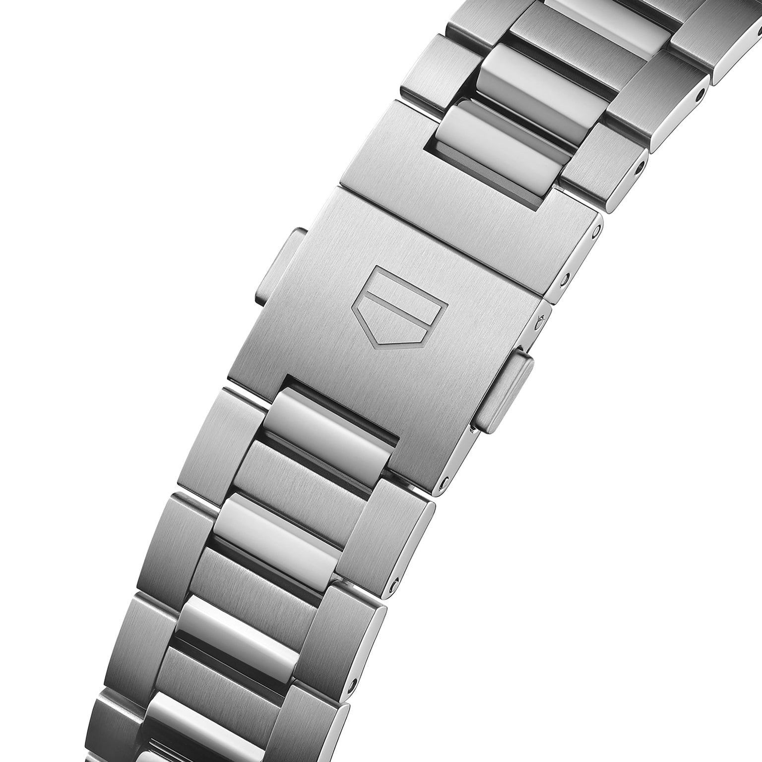 Close-up view of a stainless steel TAG Heuer Carrera Date bracelet with a clasp featuring an engraved shield logo, housing the renowned automatic movement.