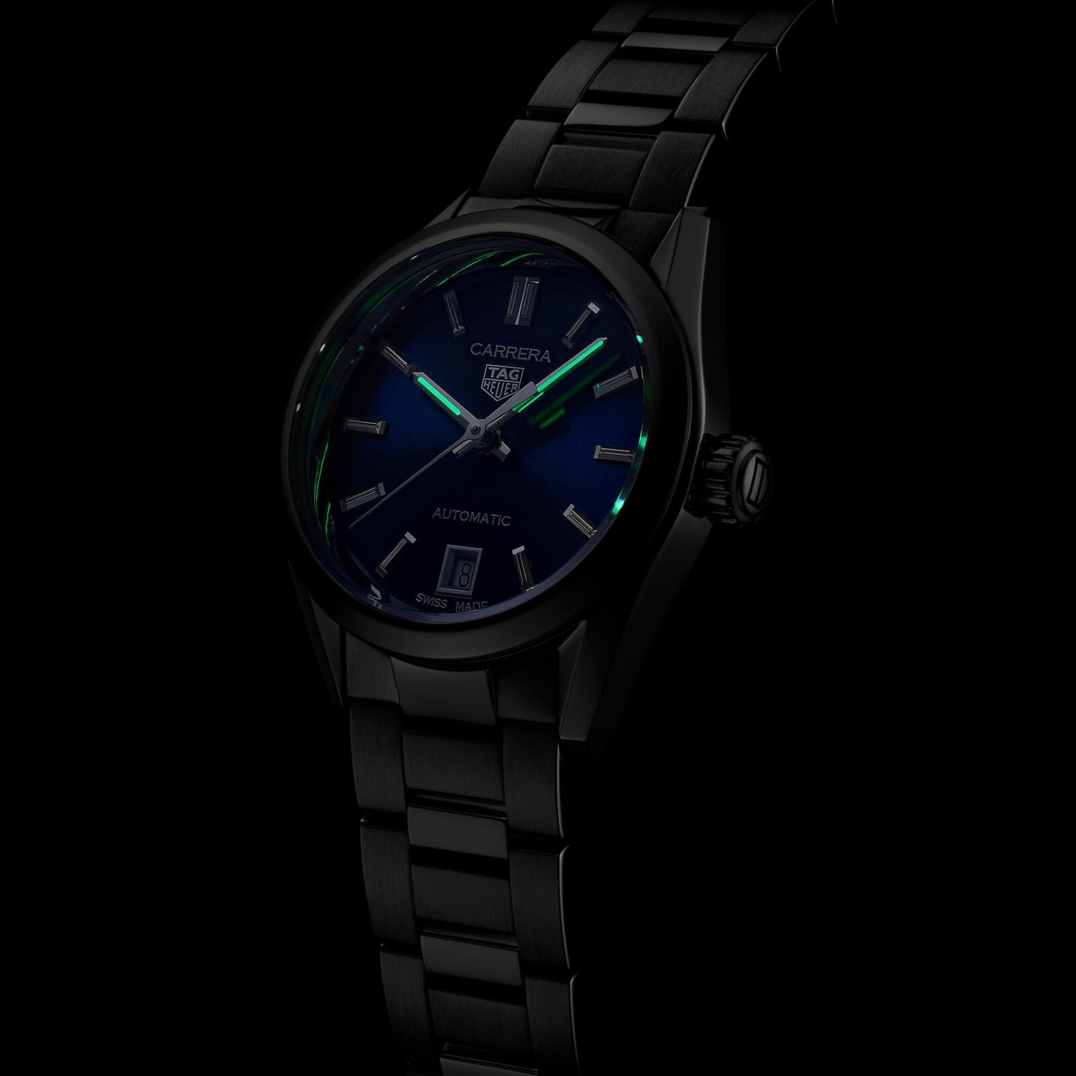 The TAG Heuer Carrera Date wristwatch features a black metal case, blue sunray dial, luminous hour markers, date display, and calibre 9 automatic movement, shown against a black background.