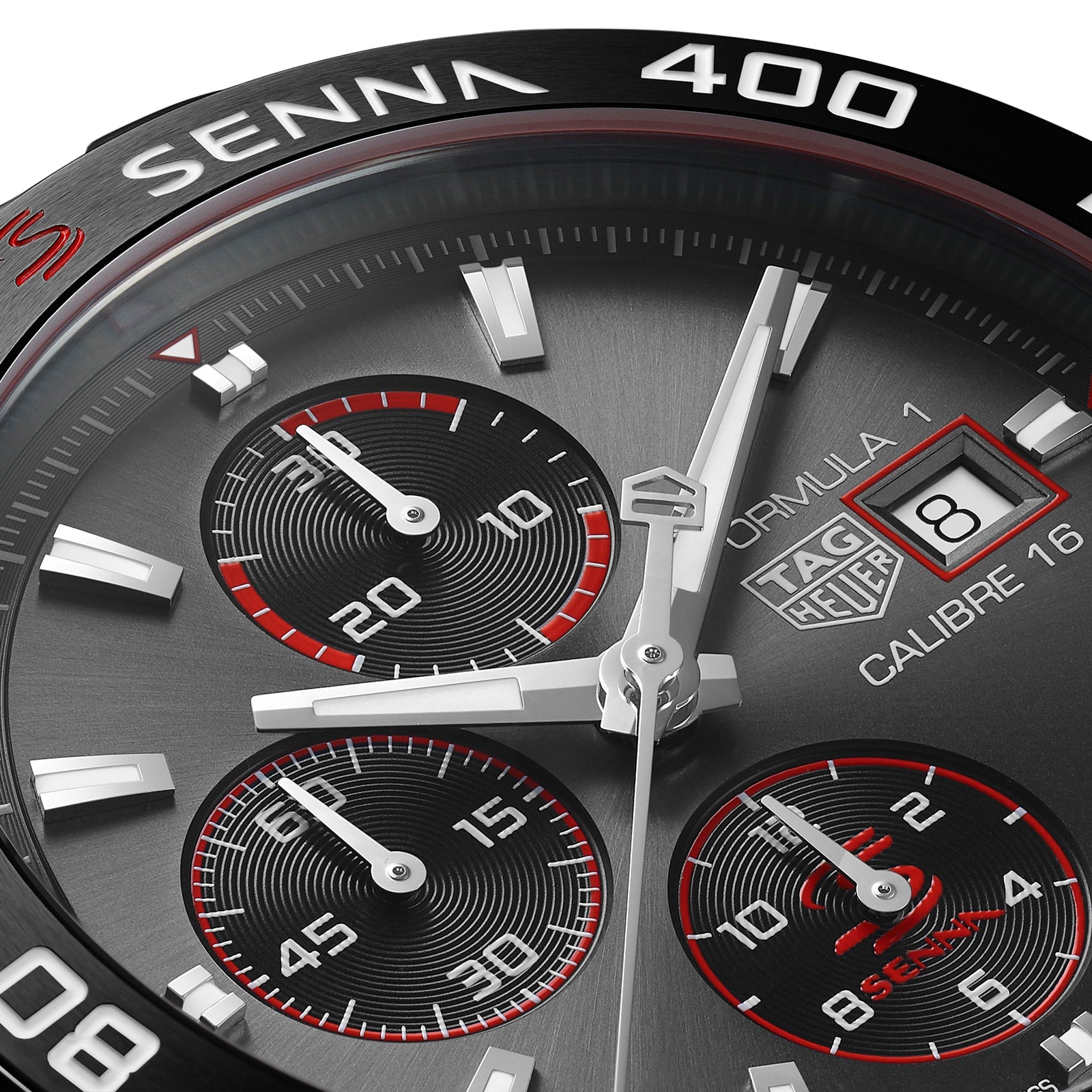 Close-up of a TAG Heuer Special Edition Formula 1 Senna watch face, showcasing three subdials, date display, and red accents on brushed metal in tribute to Ayrton Senna.