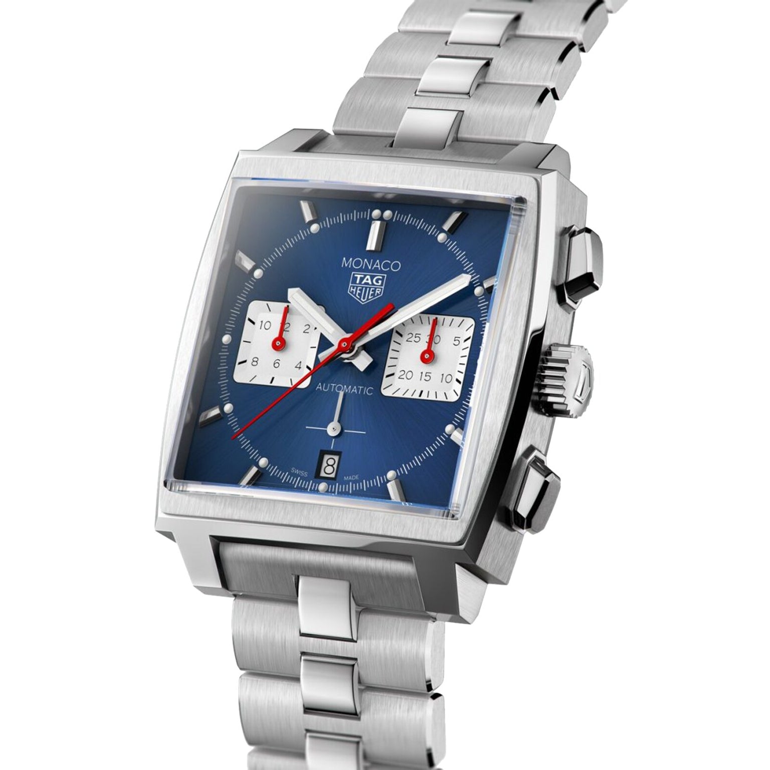 The TAG Heuer Monaco Chronograph features a silver case, blue square dial, two white subdials, date at 6 o’clock, vintage design, and a stainless steel bracelet.