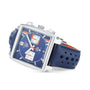 A TAG Heuer Special Edition Monaco Gulf wristwatch with a square face, chronograph dials, perforated blue leather strap, silver case, and automatic Heuer 02 movement is displayed at an angle.