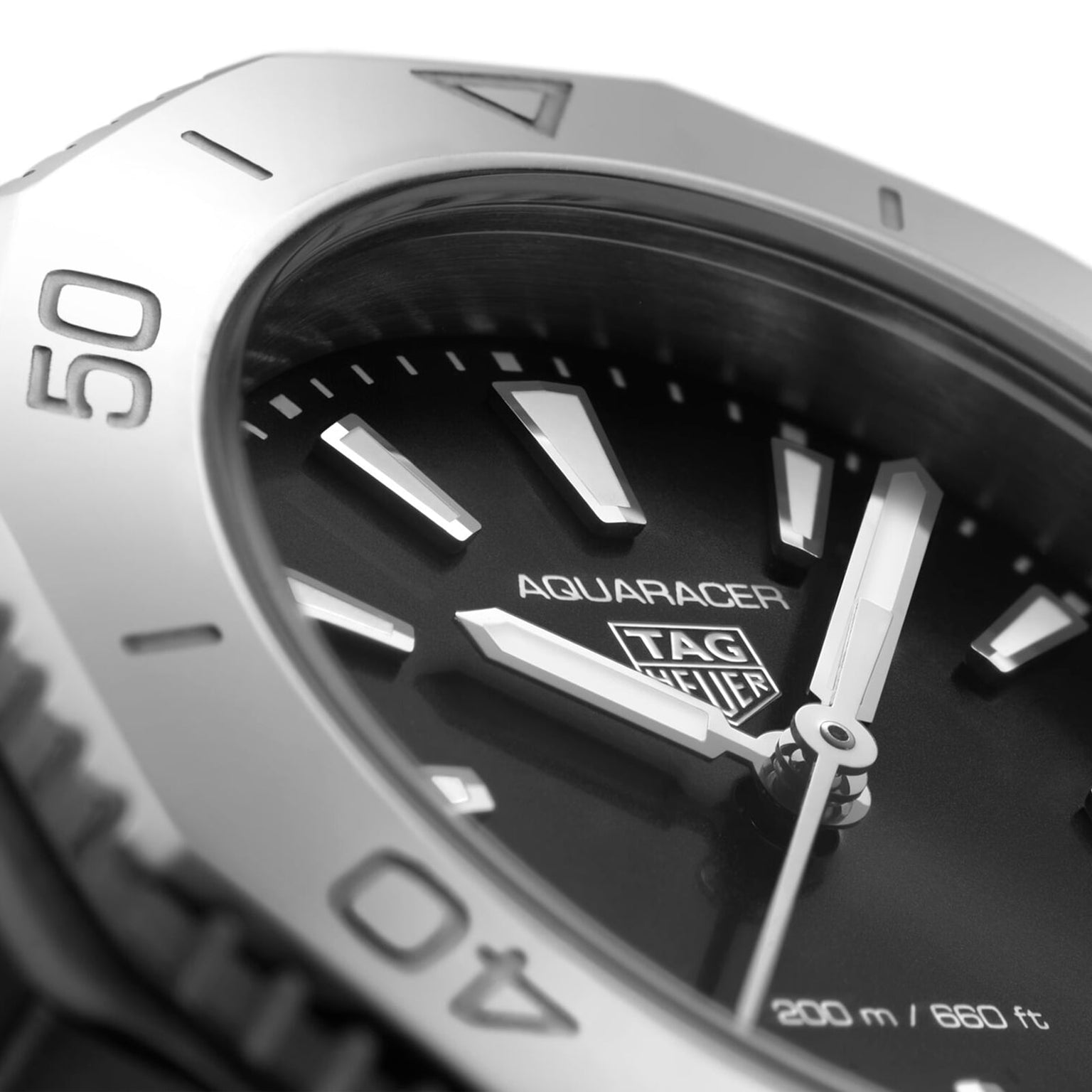 Close-up of a TAG Heuer Aquaracer Professional 200 watch face, highlighting the hands, indices, logo, 200 m / 660 ft water resistance marking, and its durable stainless steel case.