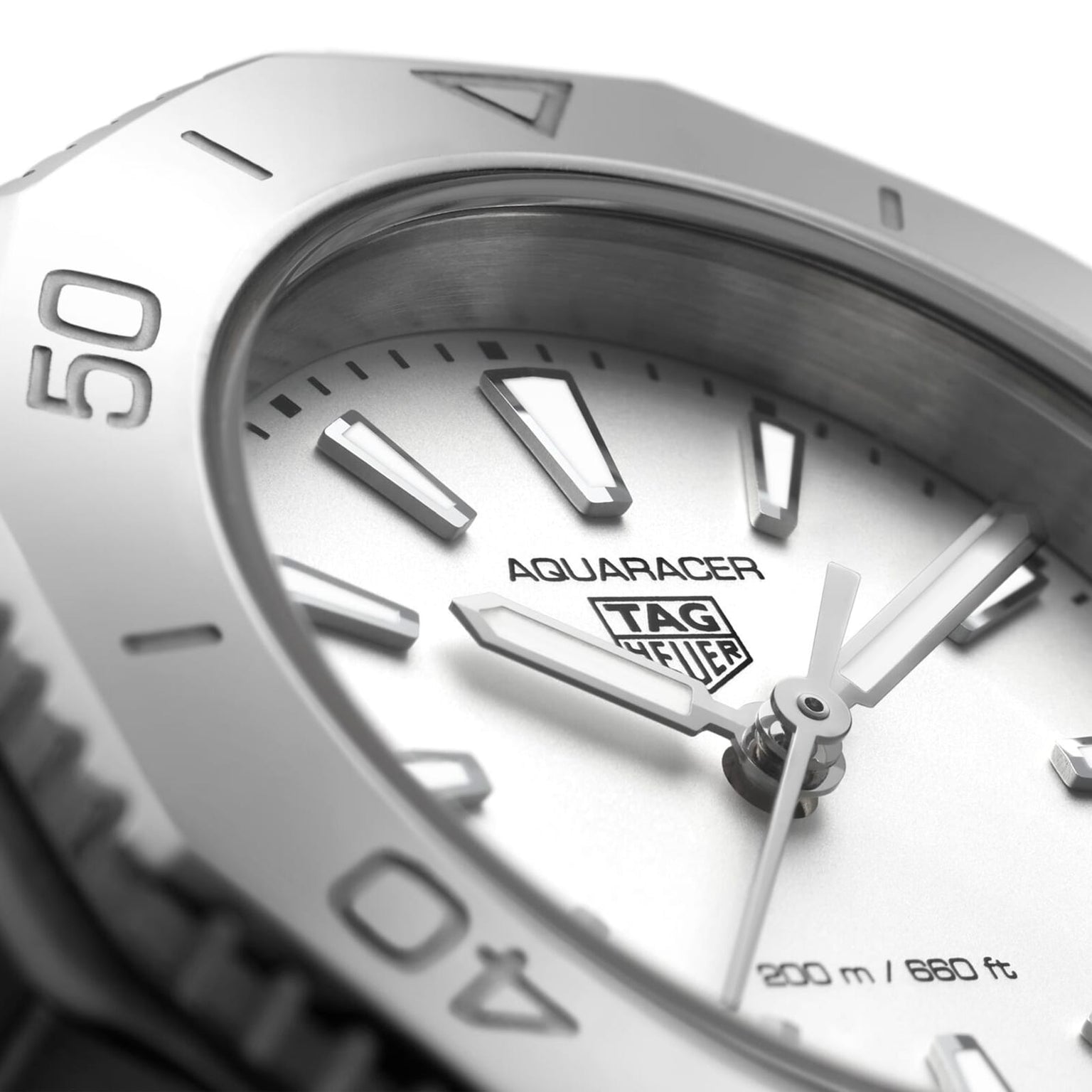 Close-up of the TAG Heuer Aquaracer Professional 200 sports watch, showing silver hour markers, hands, branding, 200m/660ft water resistance marking, and a sleek stainless steel case.