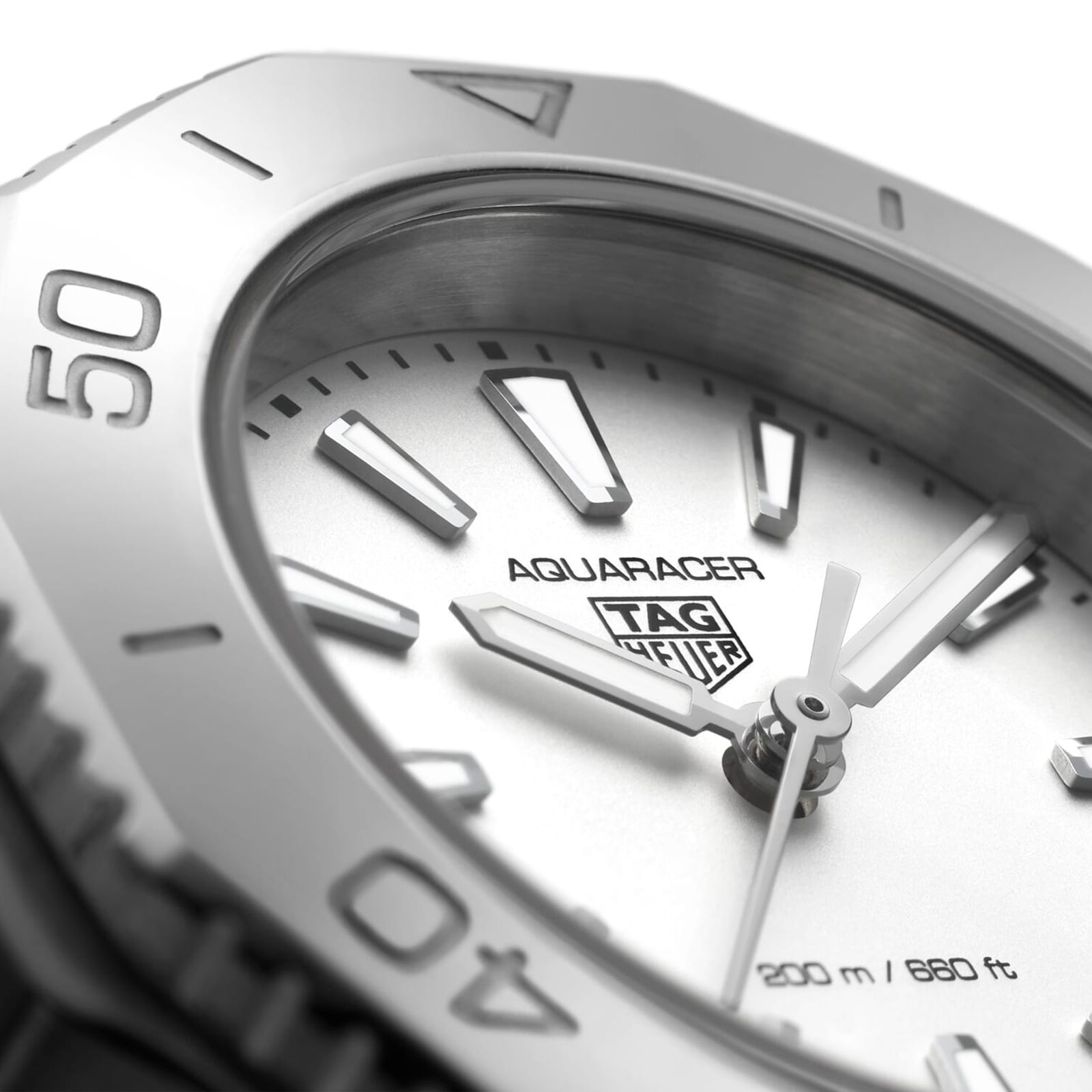 Close-up of the TAG Heuer Aquaracer Professional 200 sports watch, showing silver hour markers, hands, branding, 200m/660ft water resistance marking, and a sleek stainless steel case.