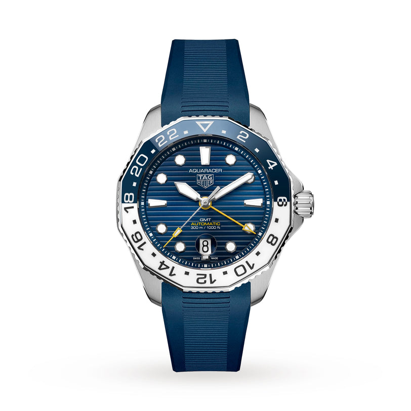 The TAG Heuer Aquaracer Professional 300 GMT is a blue and silver sports watch with a blue dial, yellow GMT hand, and blue rubber strap, shown on a white background.