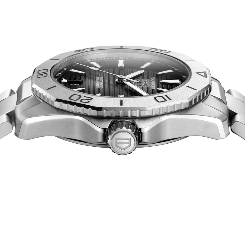 Side view of the TAG Heuer Aquaracer Professional 200 Date, a stainless steel watch with grey dial, rotating bezel, and engraved crown. Features the automatic calibre 5 movement.