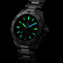 The TAG Heuer Aquaracer Professional 200 Date features a black design with luminescent green and blue hour markers and hands, set against a dark background.