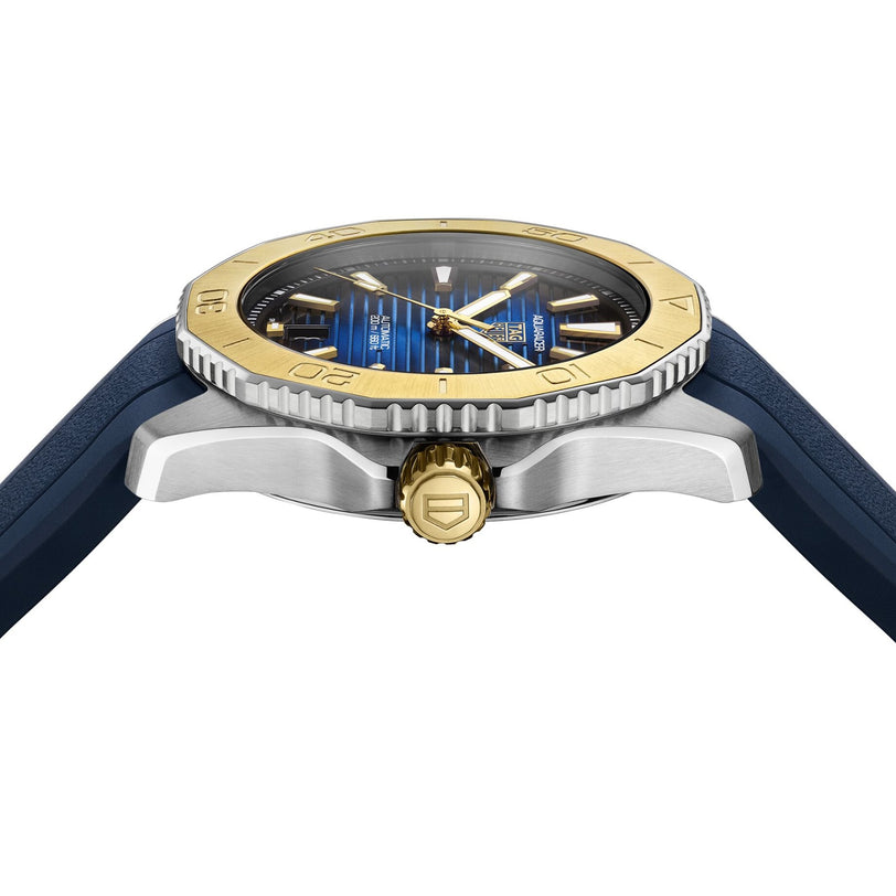 Side view of the TAG Heuer Aquaracer Professional 200 Date sports watch with a blue strap, blue and gold bezel, gold crown, and a blue dial featuring gold hour markers.