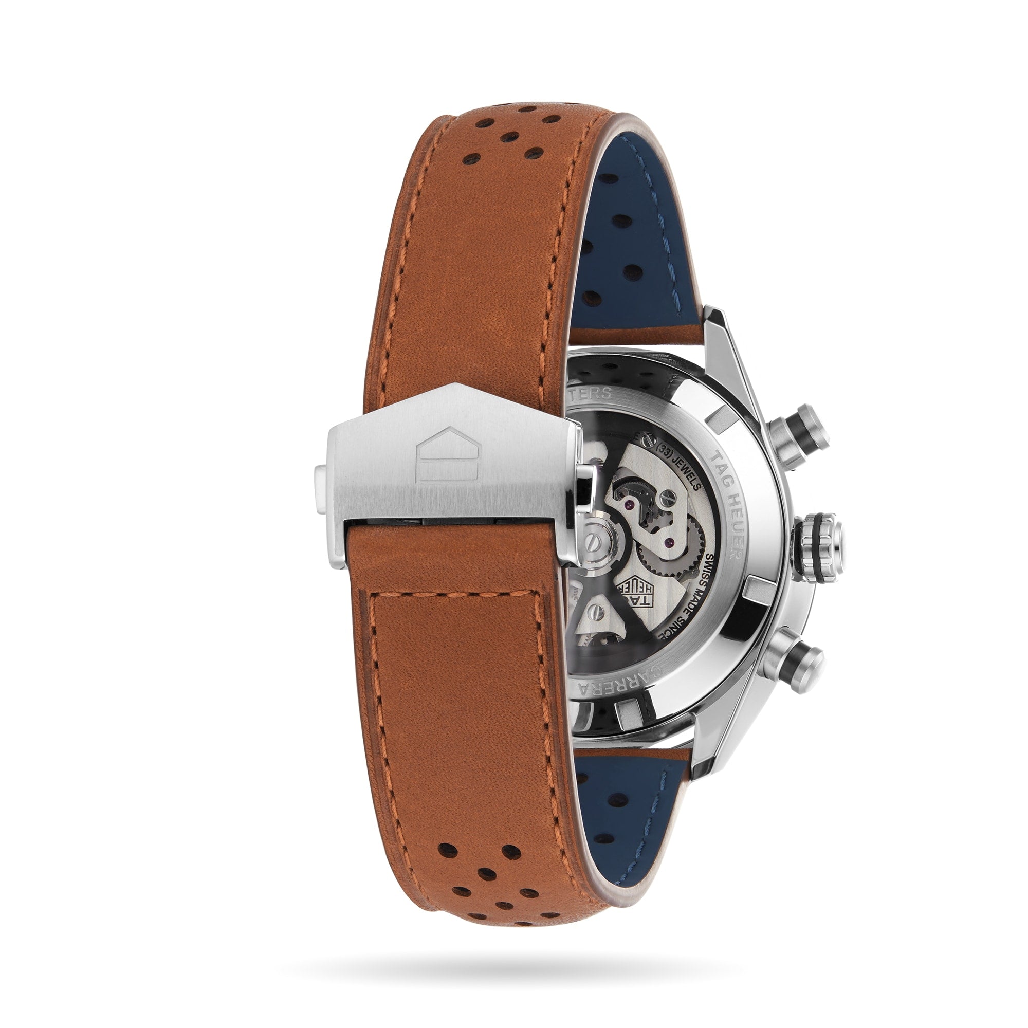 The image shows the back view of the TAG Heuer Carrera Chronograph, featuring a brown perforated leather strap and a transparent case back that reveals its calibre 02 automatic movement, highlighting its motor-racing heritage.