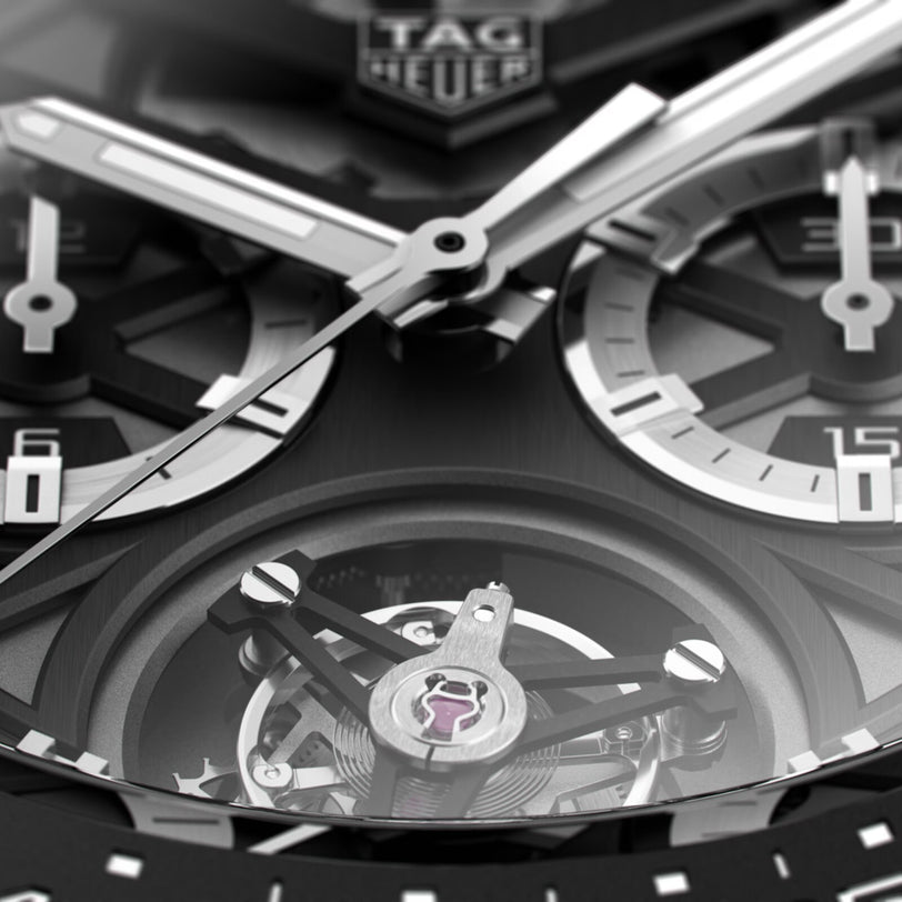 Close-up of the TAG Heuer Carrera Tourbillon Ceramic watch face, showcasing the brand logo, chronograph subdials, and its eye-catching tourbillon chronograph mechanism.