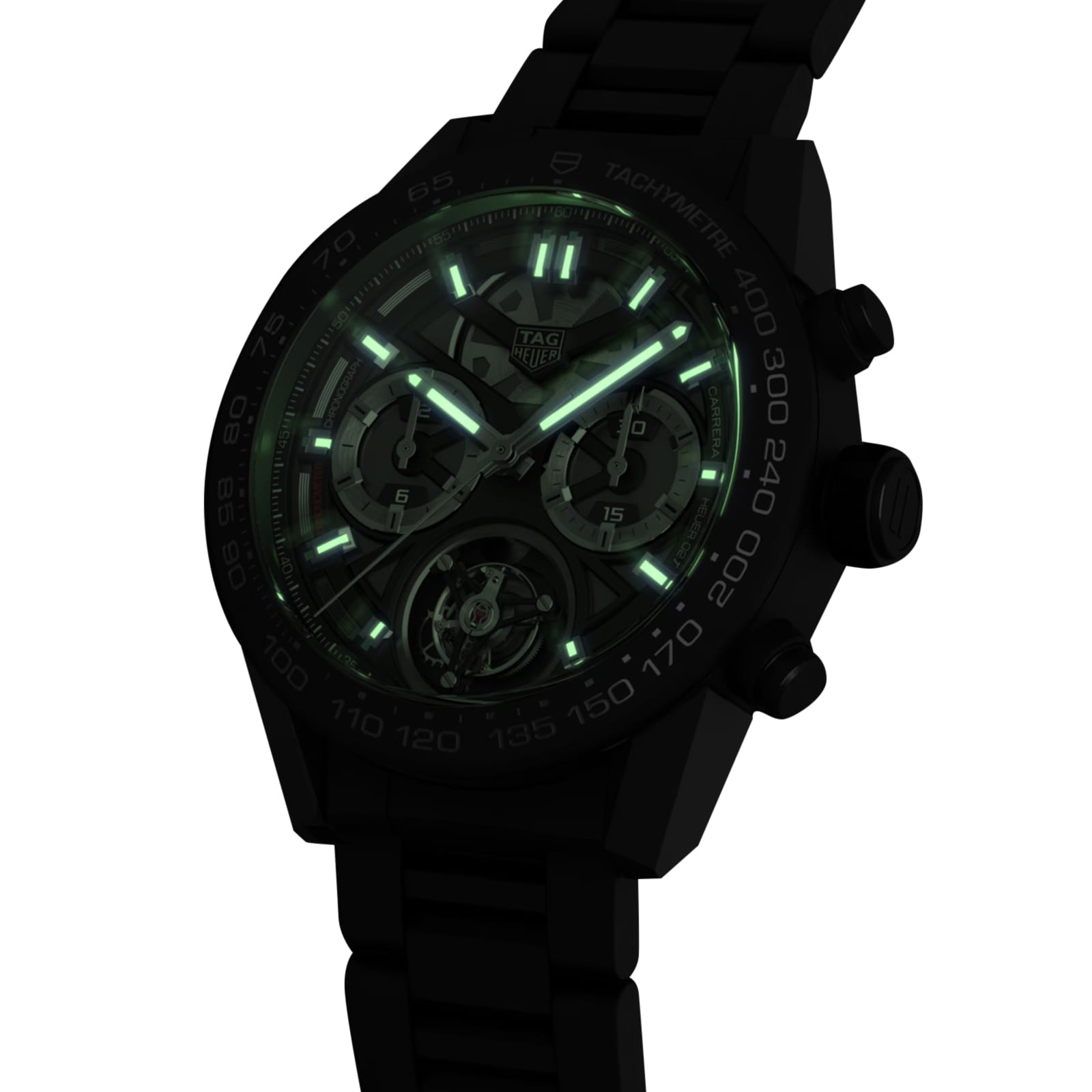 A black TAG Heuer Carrera Tourbillon Ceramic watch features glowing green luminescent markers and hands in the dark, highlighting the elegance of this timepiece.