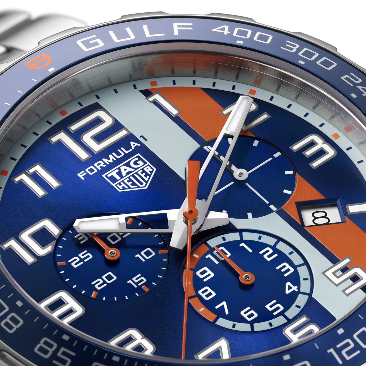 Close-up of a TAG Heuer Special Edition Formula 1 Chronograph X Gulf watch face, with blue and orange accents, three subdials, and a date window at 3 oclock.