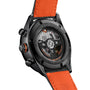 Close-up of the back of the TAG Heuer Special Edition Carrera Chronograph x Porsche Orange Racing, showing its transparent case back, visible movement, and bold orange leather strap.