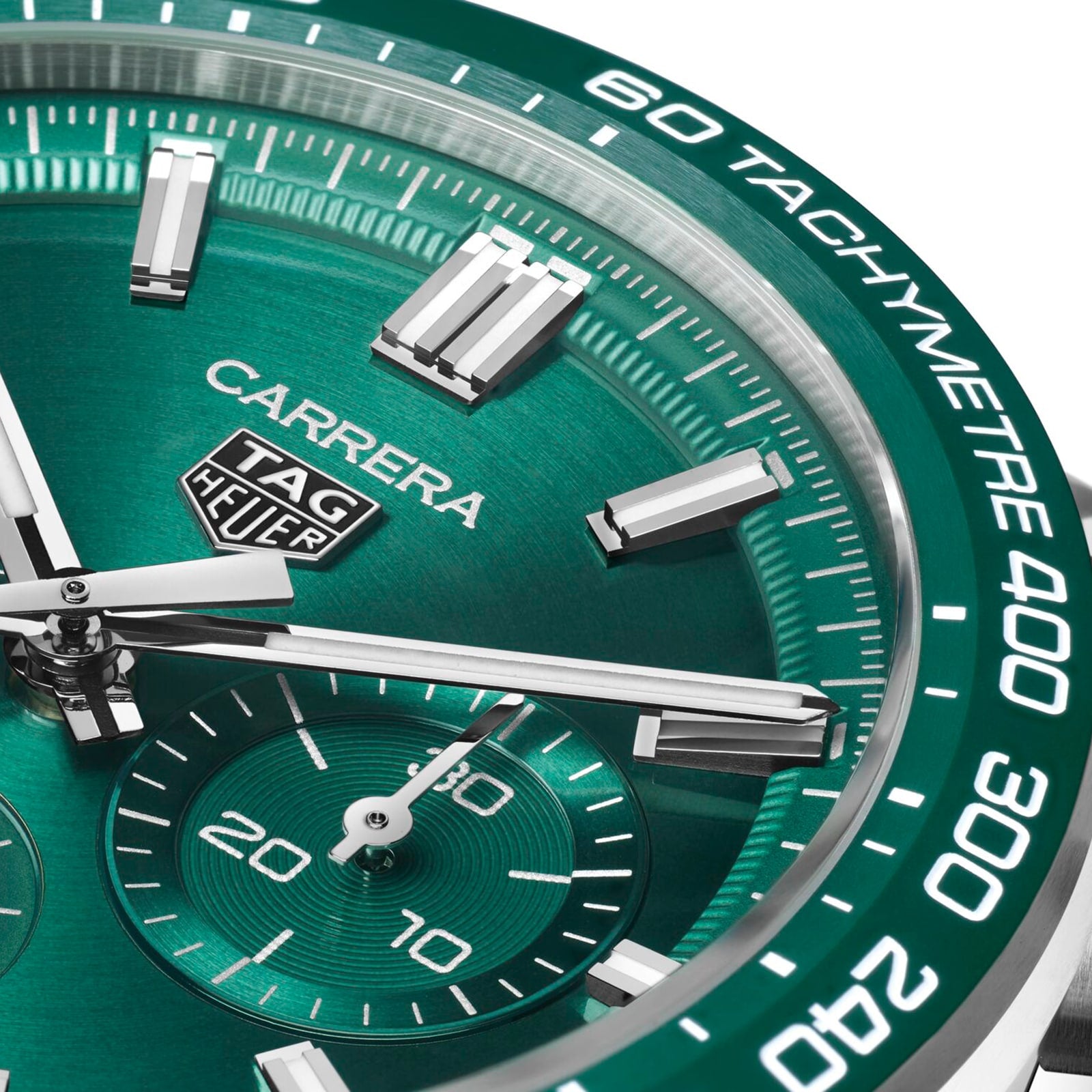 Close-up of TAG Heuer Carrera Chronograph’s green dial with silver hour markers, chronograph subdial, tachymeter scale, and Heuer 02 calibre—honoring the Carrera’s legendary motor-racing legacy.