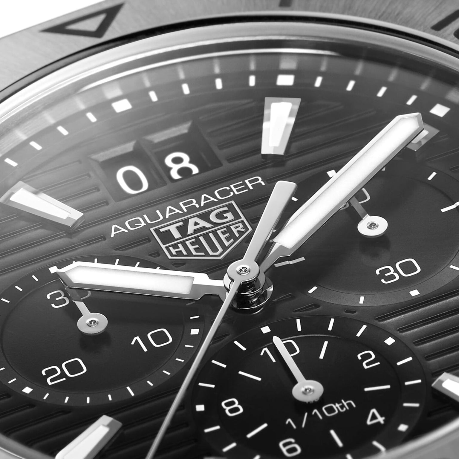 Close-up of the TAG Heuer Aquaracer Professional 200 Chronograph face displays the logo, luminous hands, chronograph subdials, and date window.