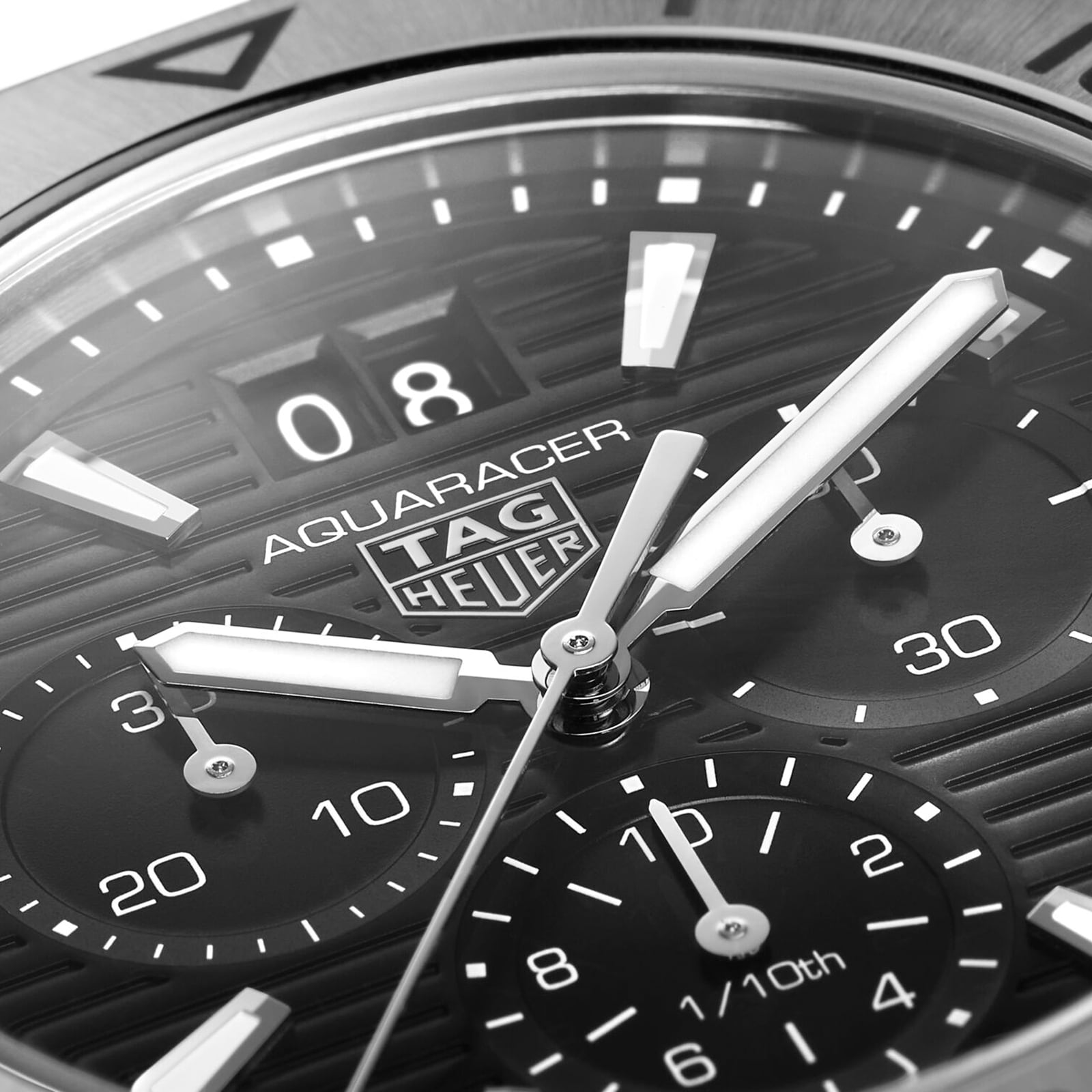 Close-up of the TAG Heuer Aquaracer Professional 200 Chronograph face displays the logo, luminous hands, chronograph subdials, and date window.