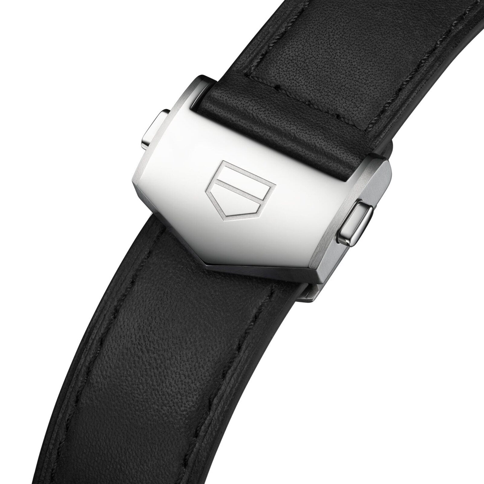 Close-up of the TAG Heuer Carrera Chronograph’s black leather strap with a silver clasp engraved with a geometric logo, showcasing its automatic movement.