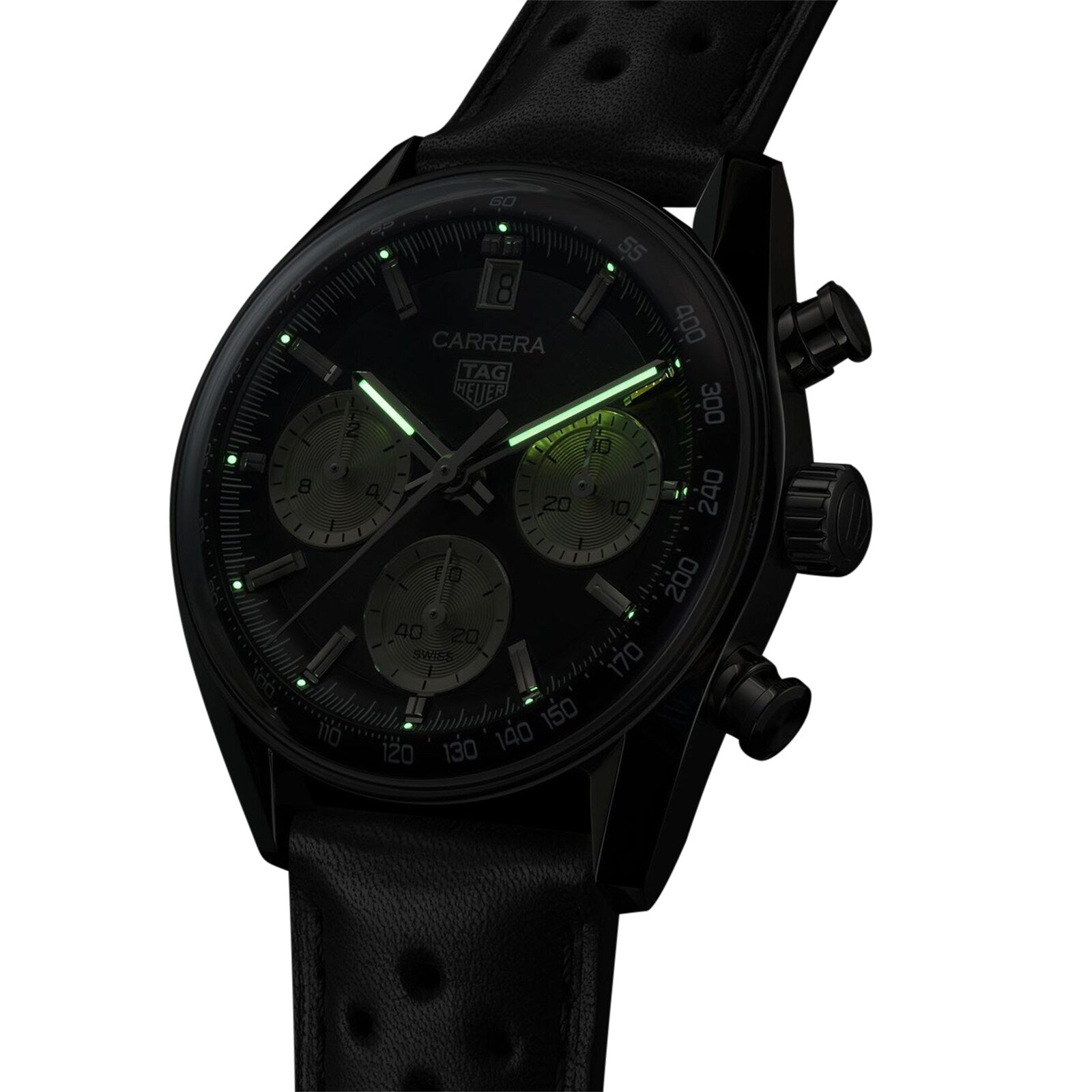 The TAG Heuer Carrera Chronograph is a black watch with a perforated leather strap and luminous green hands and hour markers, powered by an automatic movement.
