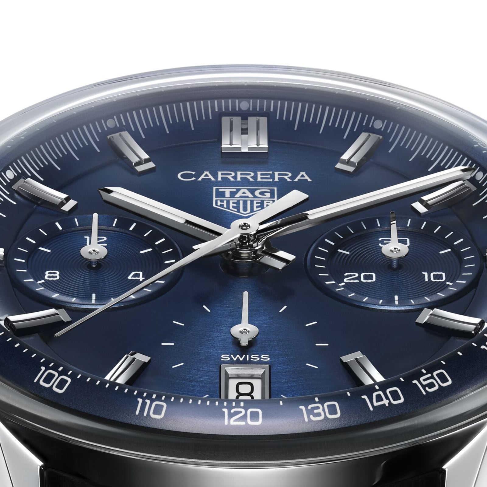 Close-up of a TAG Heuer Carrera Chronograph watch, featuring a blue dial, silver markers and hands, chronograph subdials, Calibre TH20-00 movement, and a date window at 6 o’clock.