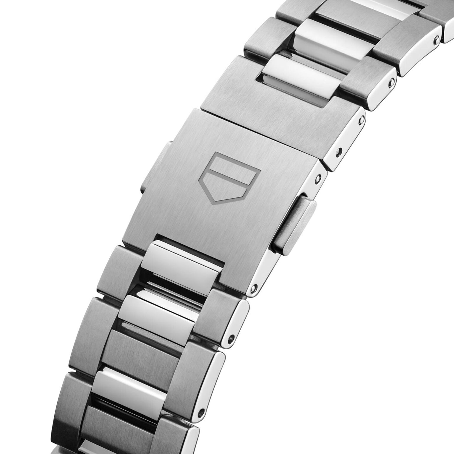 Close-up of a TAG Heuer Carrera Date stainless steel bracelet, showcasing refined elegance and a clasp engraved with the iconic shield logo.
