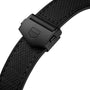 Close-up of a black fabric watch strap with matte black clasp and geometric logo, complementing the bold titanium case of the TAG Heuer Monaco Chronograph.