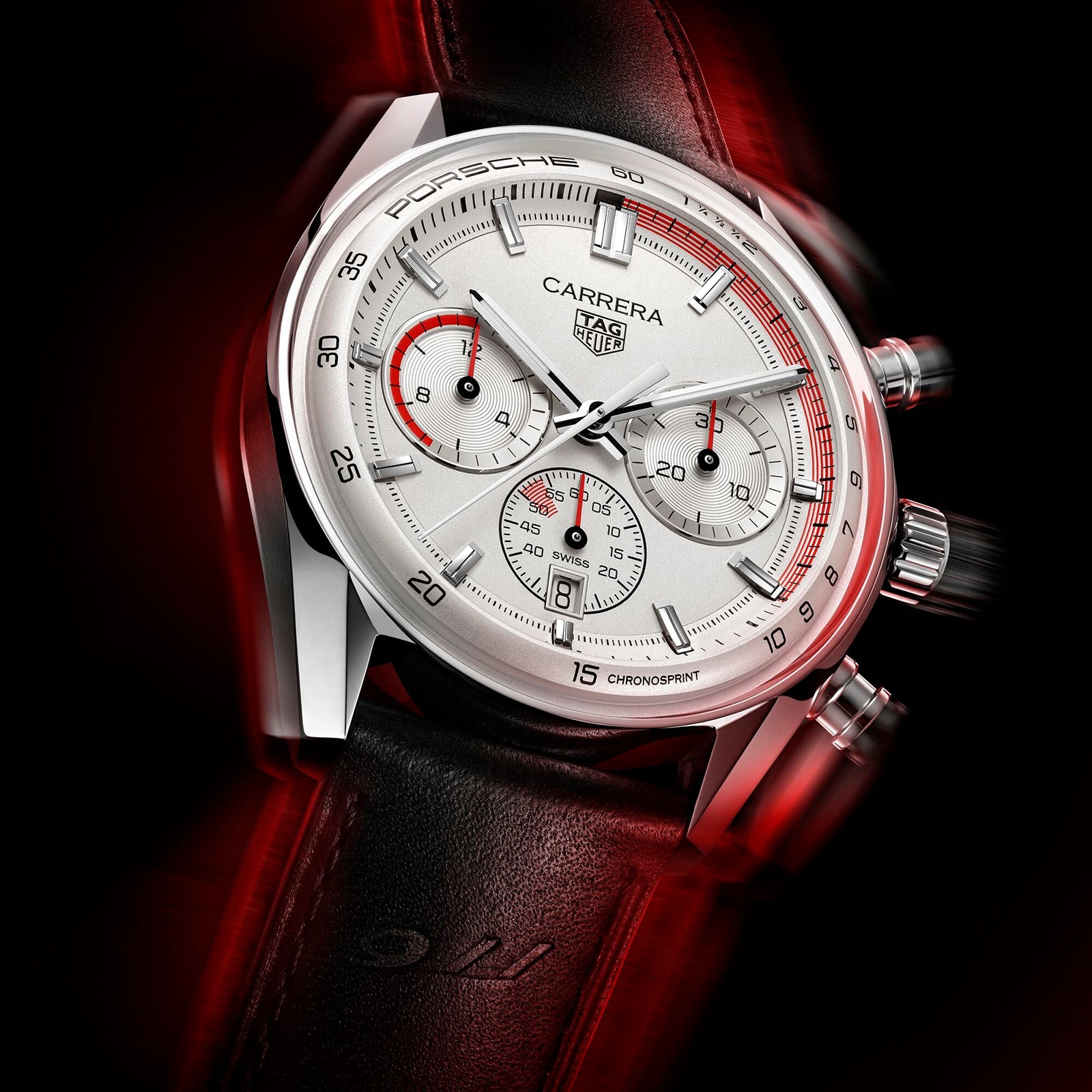 Close-up of the TAG Heuer Special Edition Carrera Chronosprint x Porsche watch with three subdials, black leather strap, and red accents—its chronograph movement reflecting the iconic spirit of Porsche 911—set against a black and red background.