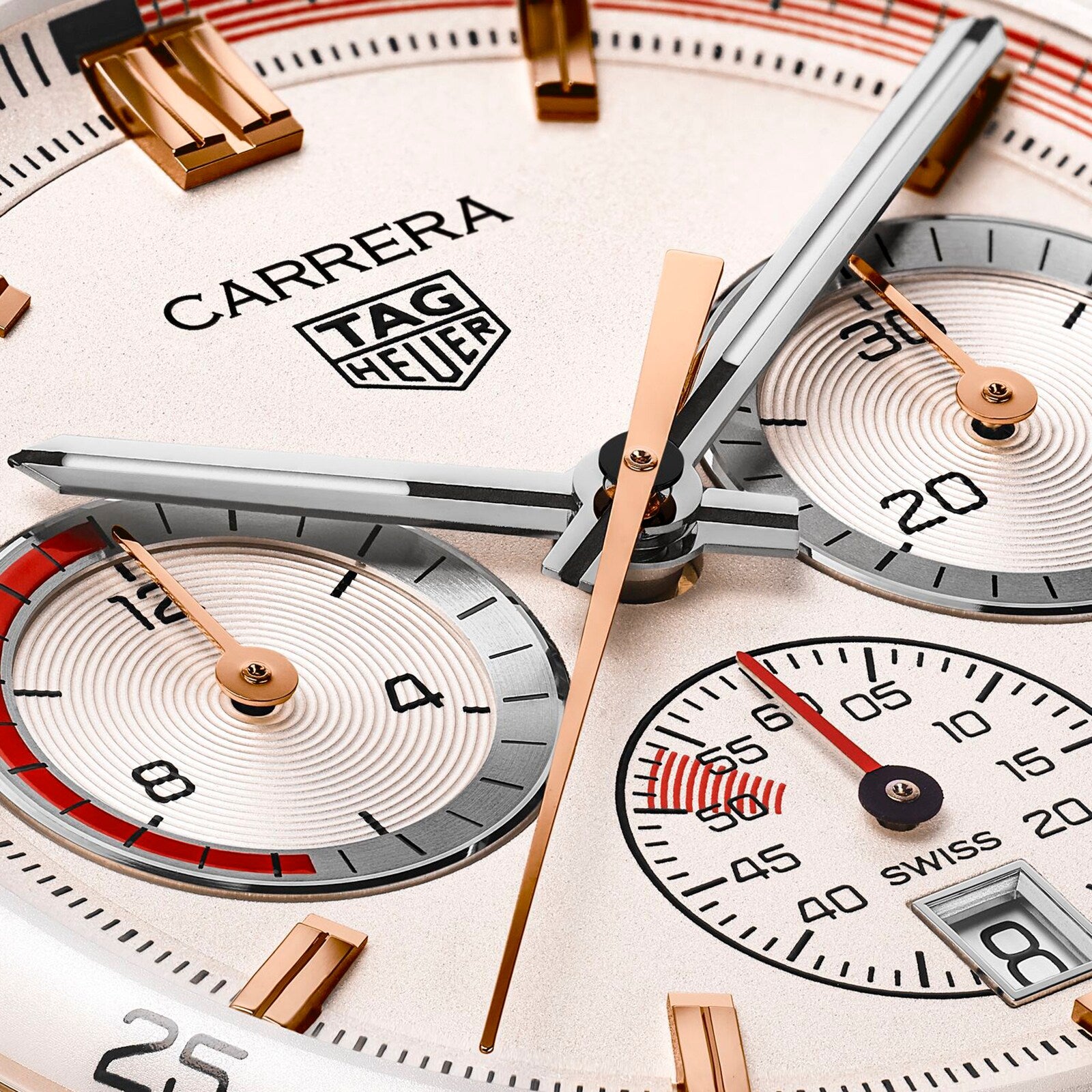 Close-up of a TAG Heuer Special Edition Carrera Chronosprint x Porsche watch face, featuring three subdials, gold and silver hands, indices, the TAG Heuer logo, and automatic chronograph movement details.