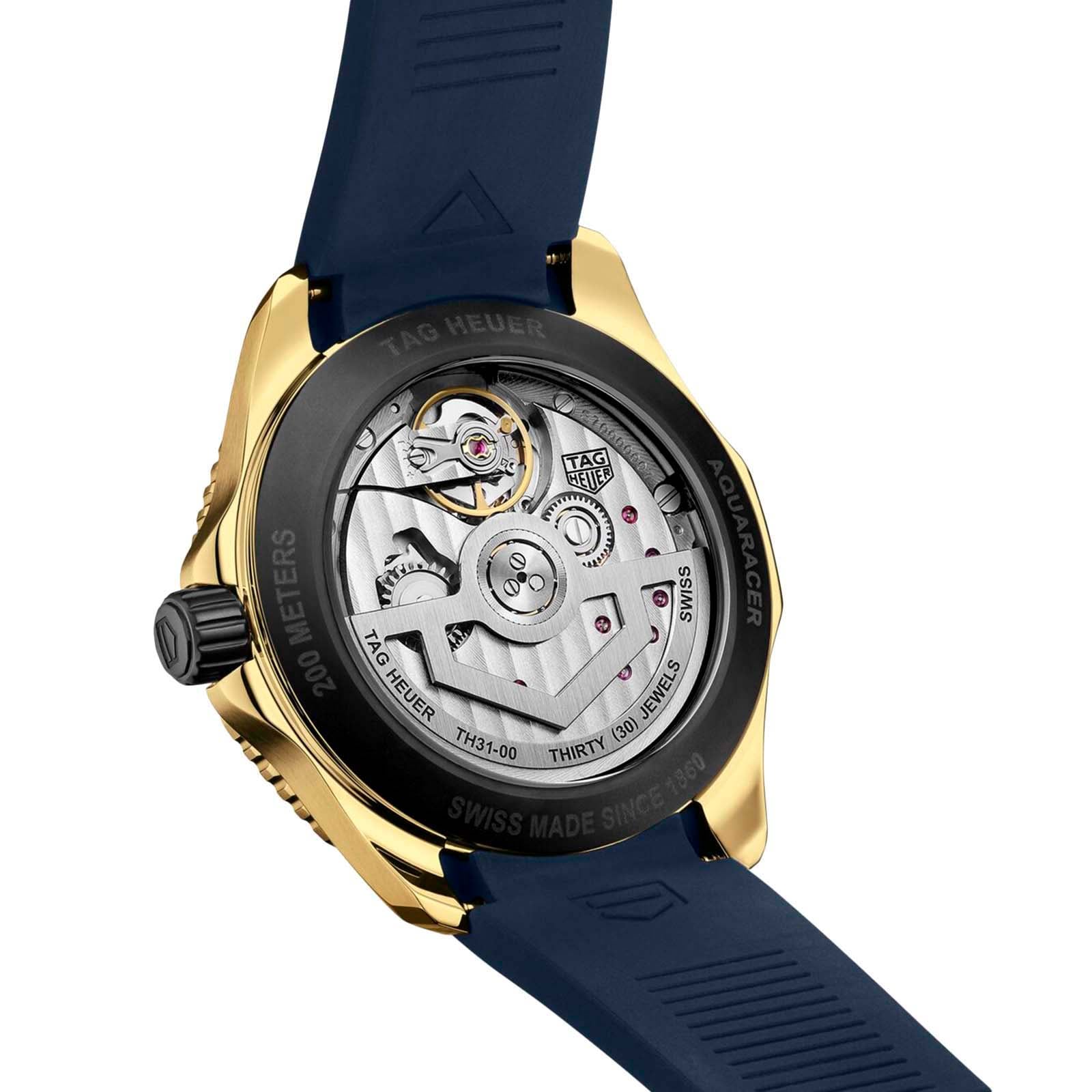 Close-up of the TAG Heuer Aquaracer Professional 200 Dates back, showcasing its yellow gold case, blue strap, and visible TH31-00 calibre movement.