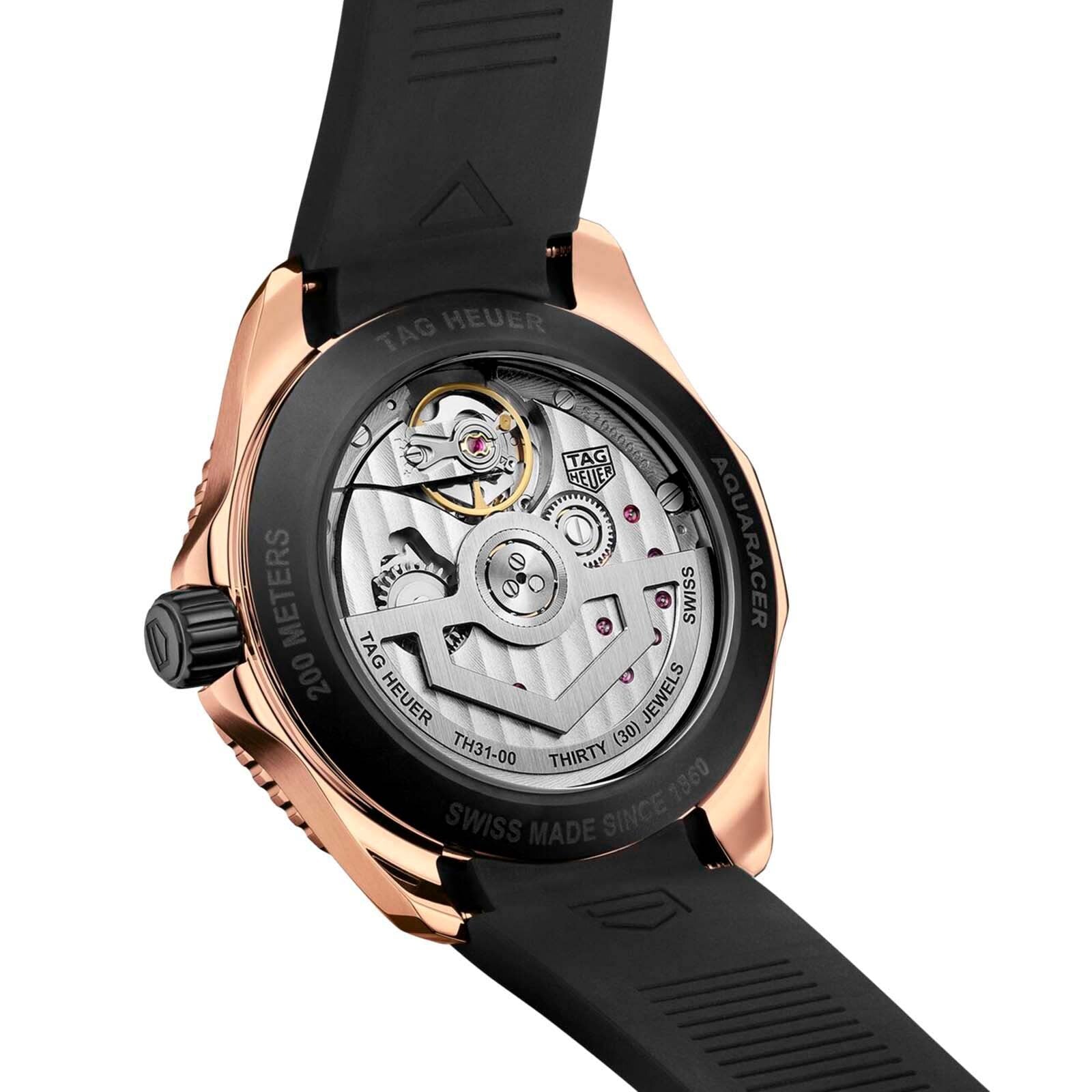 Close-up of the back of a TAG Heuer Aquaracer Professional 200 watch, showing the transparent case with TH31-00 calibre movement and rose gold engraved rim details.