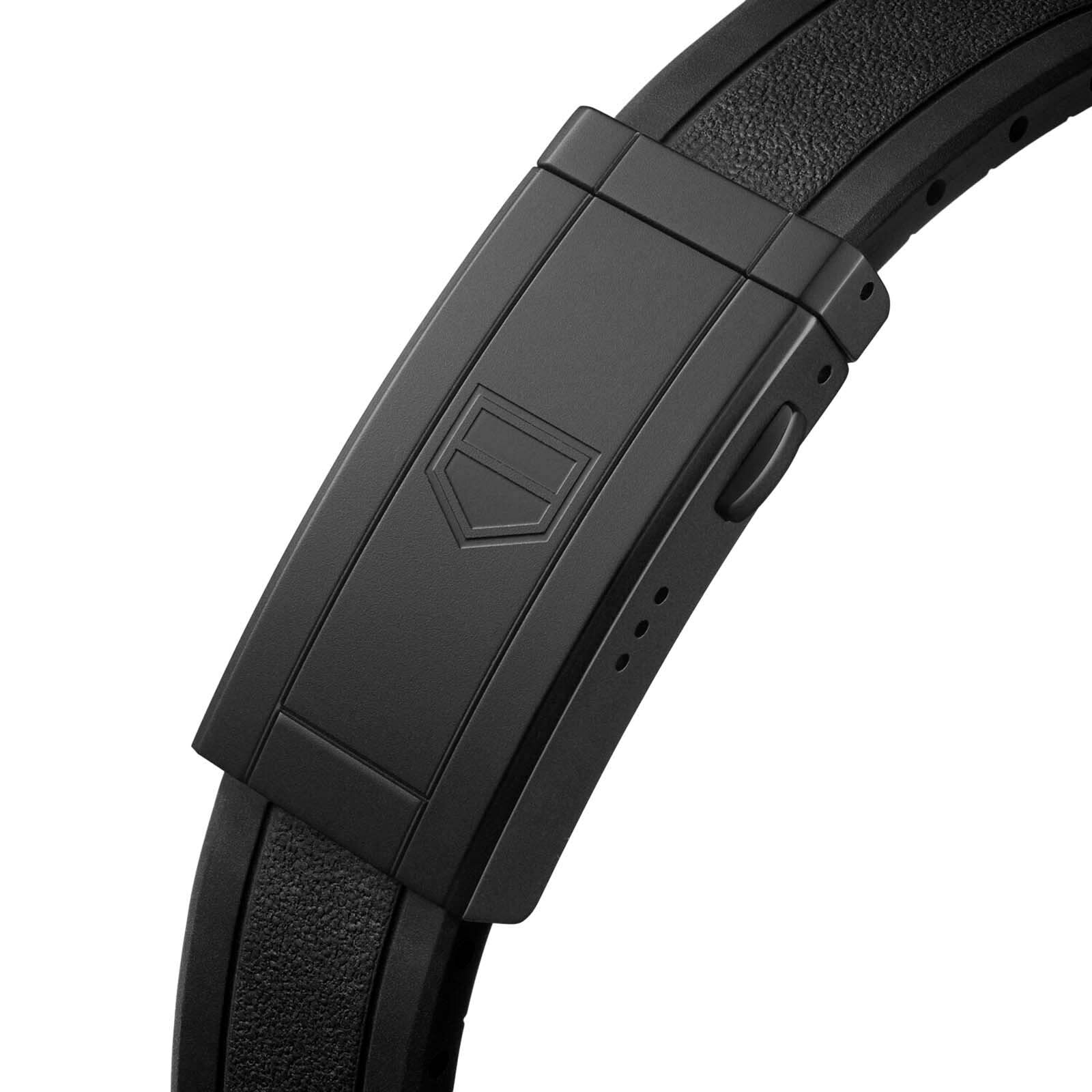 Close-up of a black clasp with a geometric logo on a textured leather strap, showcasing an elegant detail from the TAG Heuer Aquaracer Professional 200.