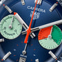 Close-up of the TAG Heuer Carrera Chronograph Skipper watch face, showing two Skipper subdials (one green, one green/red), silver and orange hands, all inspired by the Carrera Panamericana and powered by the TH20-06 calibre.