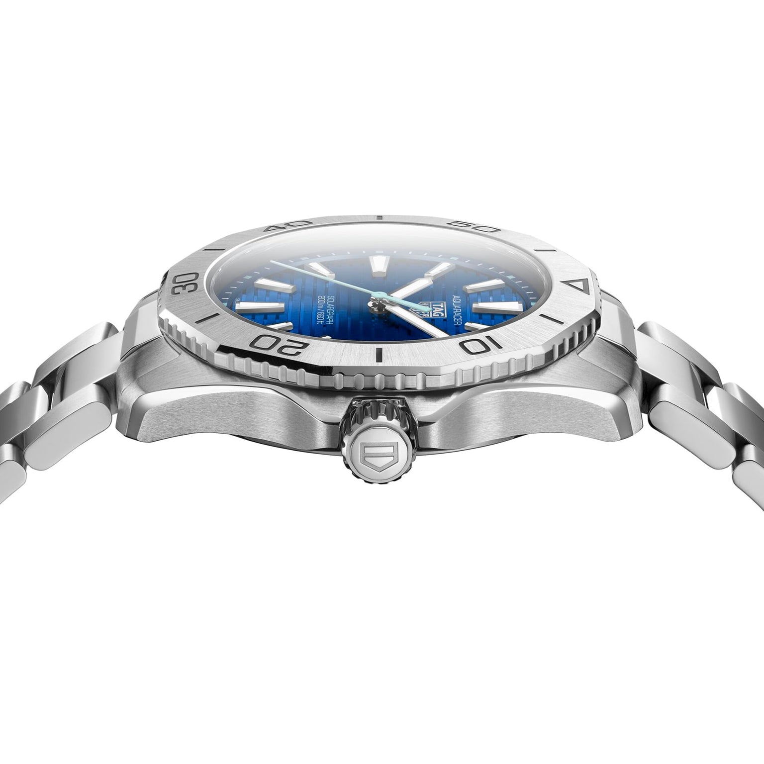 Side view of a TAG Heuer Aquaracer 200 Professional Solargraph with a blue dial, silver numbered bezel, and stainless steel bracelet. The TAG Heuer crown logo is visible on the side.