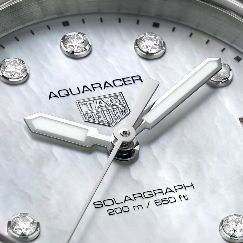 Close-up of a TAG Heuer Aquaracer 200 Professional Solargraph watch face, showcasing diamond hour markers, silver hands, and 200m/650ft water resistance.