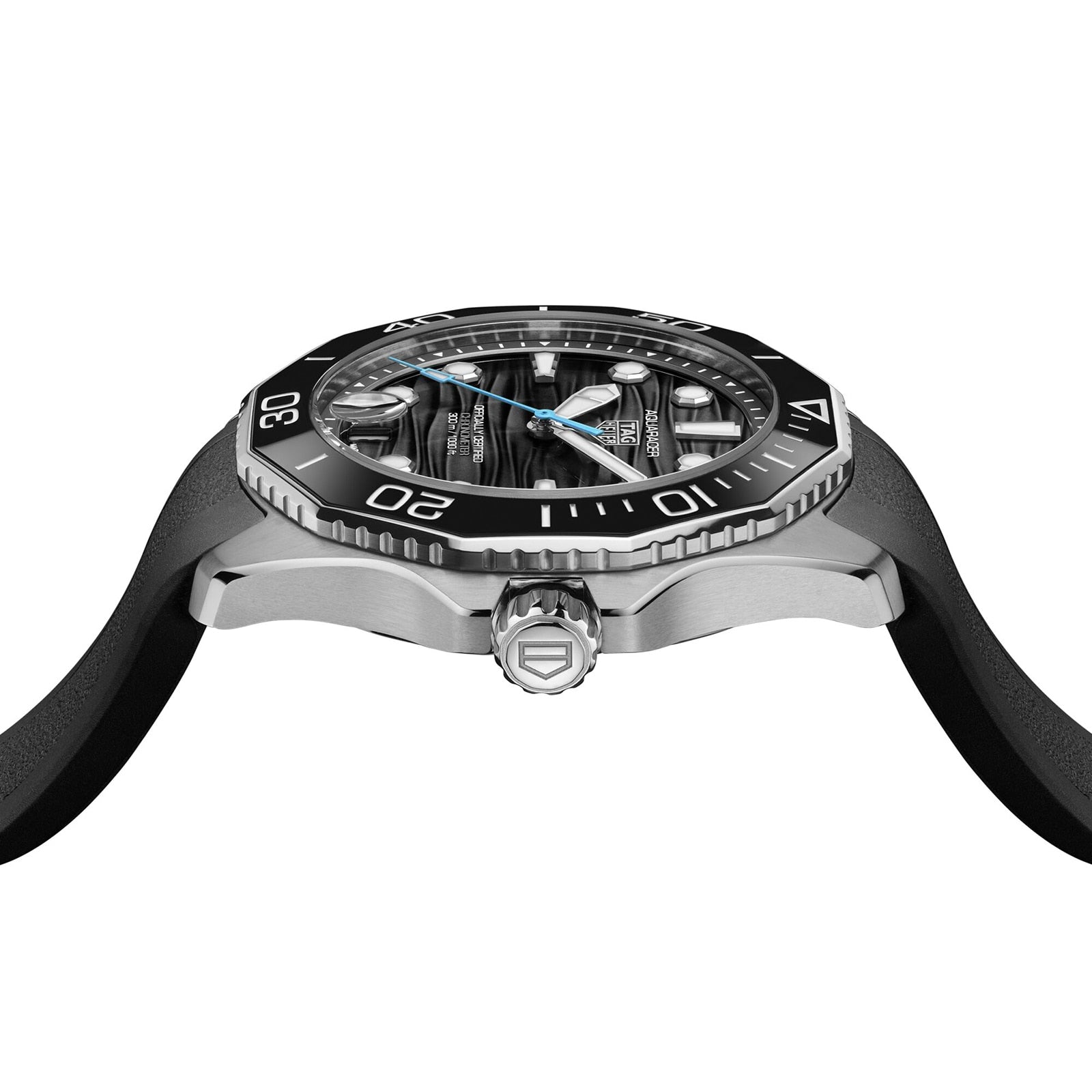 Side view of the TAG Heuer Aquaracer Professional 300 Date, showcasing a black bezel, silver case, black rubber strap, and exposed mechanical movement—highlighting this luxury watch’s distinctive design.