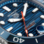 Close-up of the TAG Heuer Aquaracer Professional 300 Date watch face with a blue textured dial, bold white markers, and 300 m / 1000 ft water resistance—ideal for deep-sea exploration.