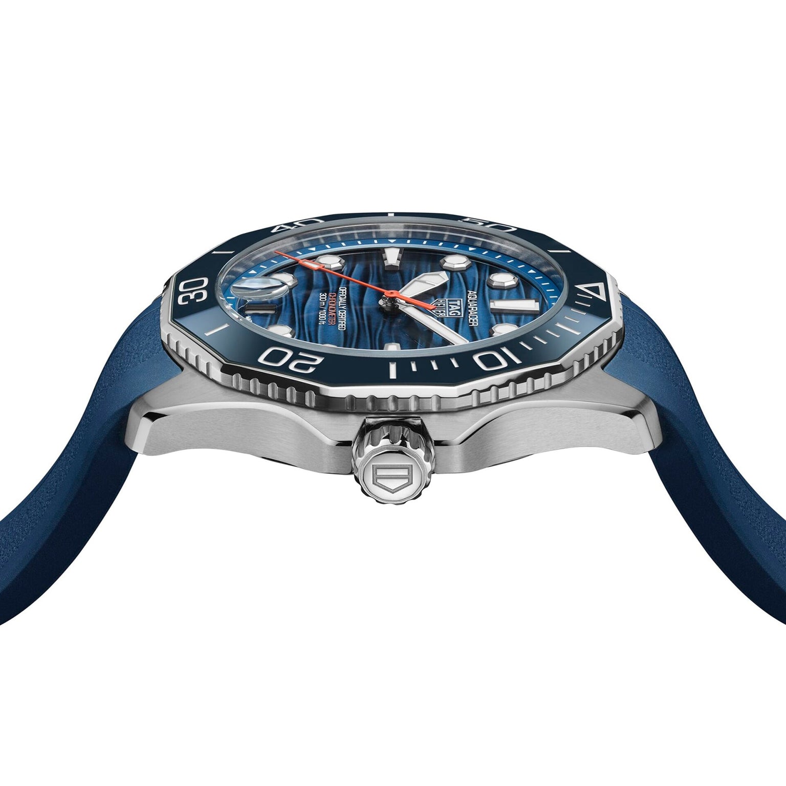 A side view of the TAG Heuer Aquaracer Professional 300 Date shows its blue textured dial, silver bezel, and blue strap, with visible crown and bezel markers—designed for deep-sea exploration.