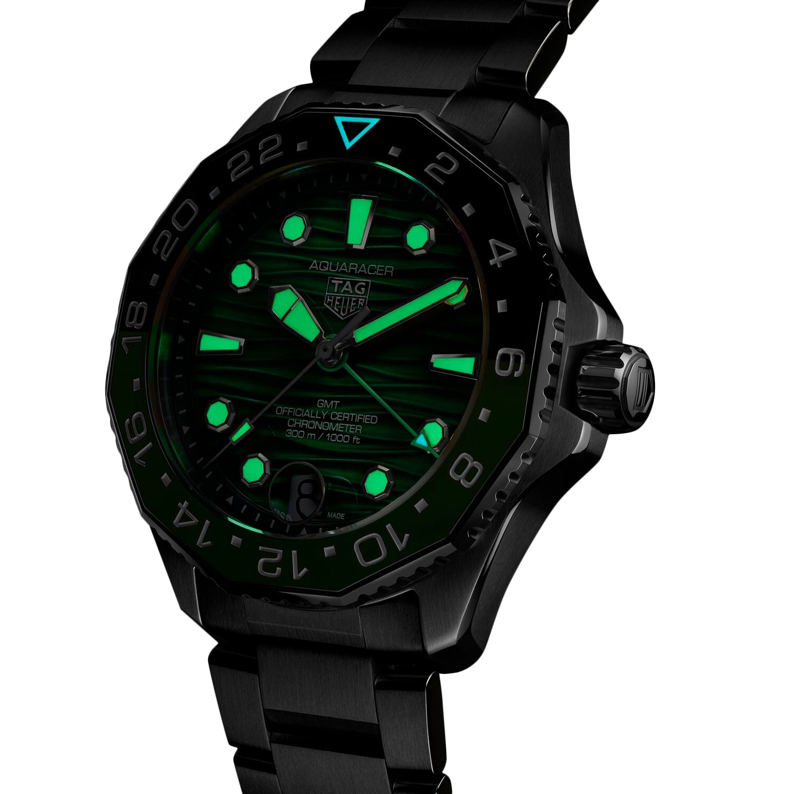 TAG Heuer Aquaracer Professional 300 GMT with luminous green markers and hands, black dial, and stainless steel bracelet, displayed against a white background.