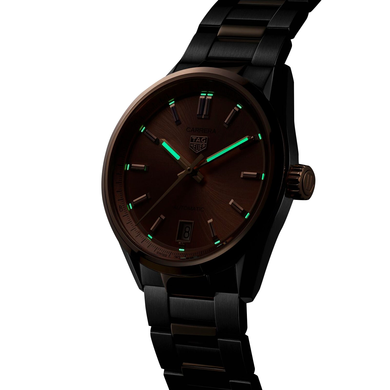 A TAG Heuer Carrera Date wristwatch with a dark metallic band, brown dial, date window, and green luminescent hour markers, powered by an automatic movement, is shown against a white background.