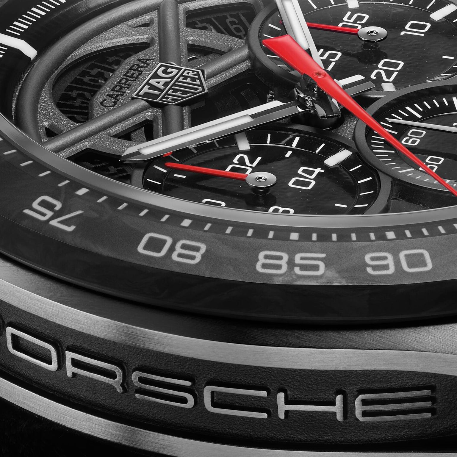 Close-up of a TAG Heuer Limited Edition Carrera Chronograph x Porsche 963 watch face, highlighting its detailed dials, hands, and prominent branding on the bezel and dial.