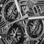 Close-up of a TAG Heuer Carrera Chronograph Extreme Sport watch face, showcasing a skeleton design with visible gears, black and silver subdials, and sleek silver hands.