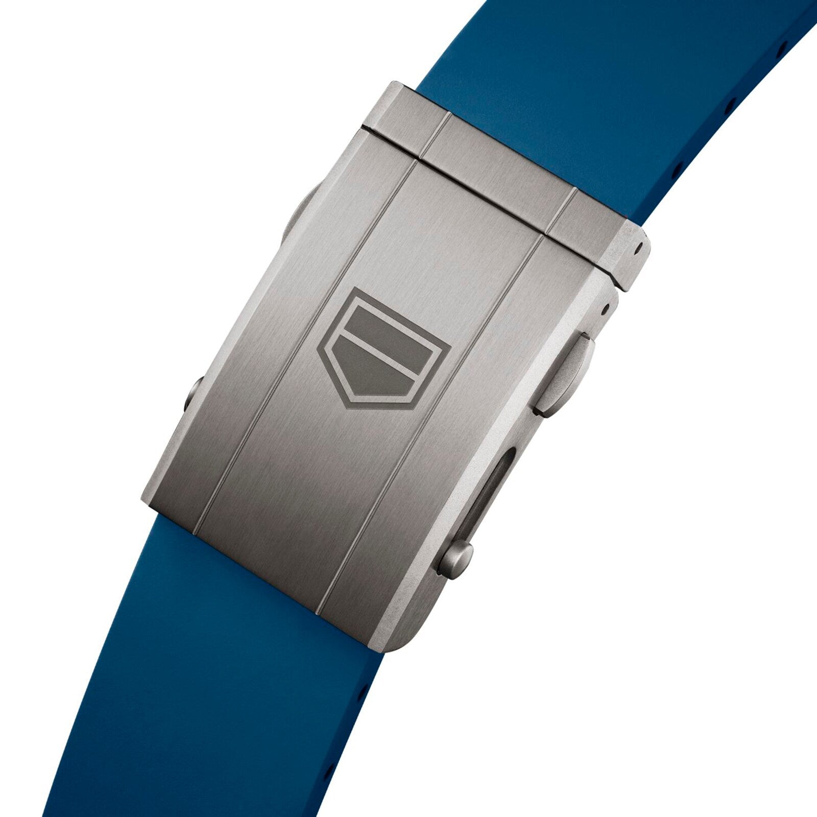 Close-up of a metal clasp engraved with the TAG Heuer logo, attached to a blue silicone strap from the Carrera Chronograph Extreme Sport collection.