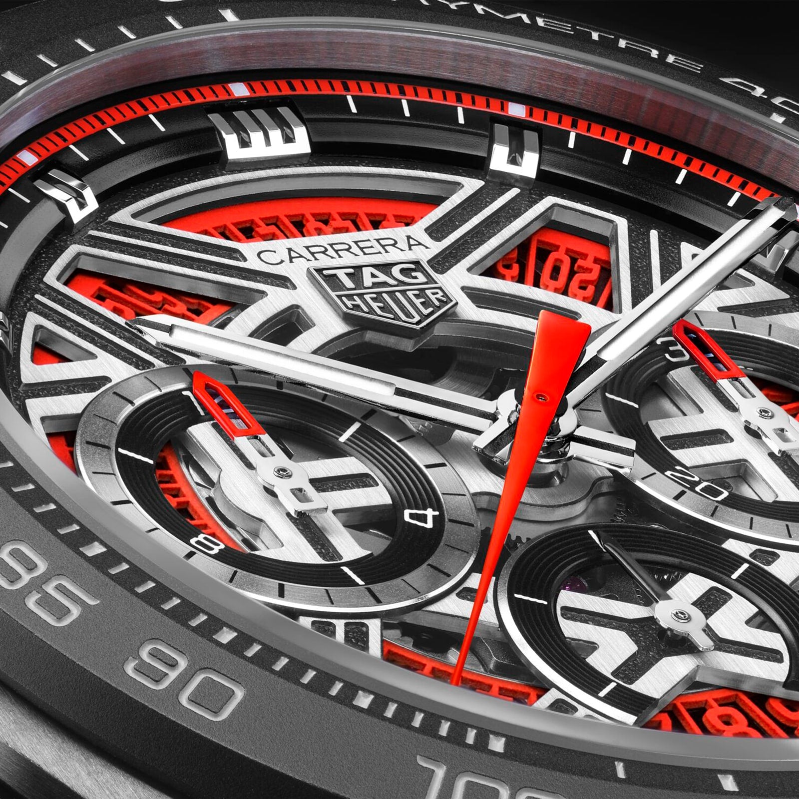 Close-up of the TAG Heuer Carrera Chronograph Extreme Sport watch face, featuring red, black, and silver accents with detailed chronograph dials.