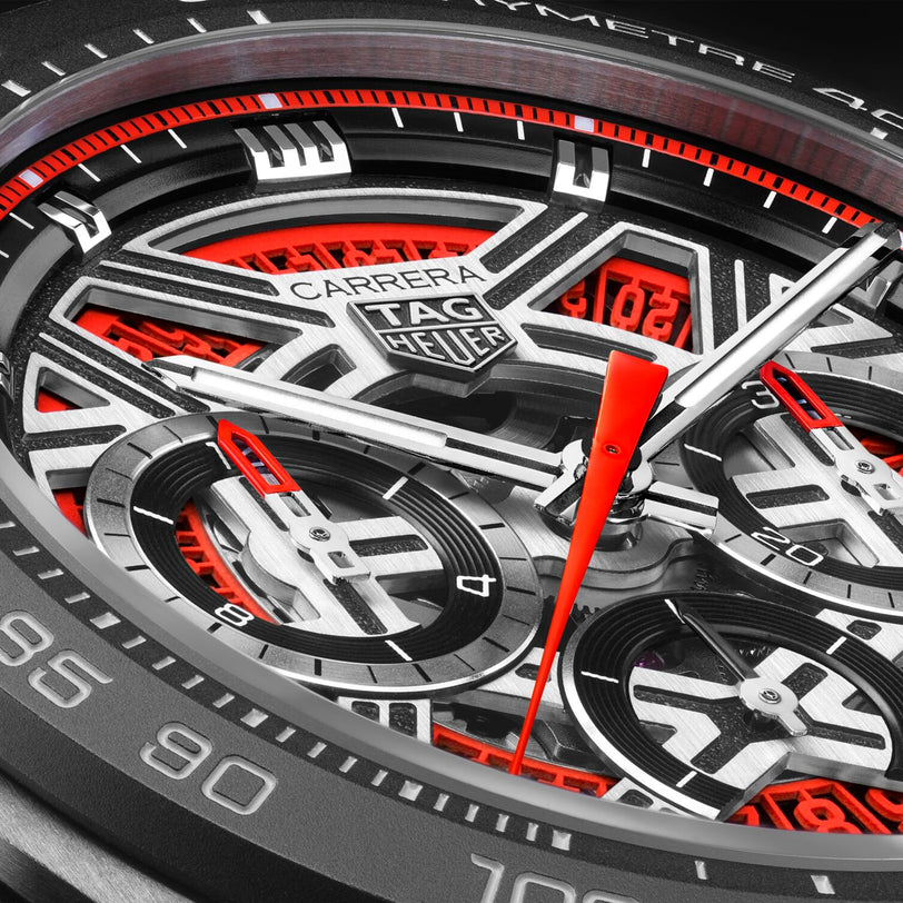 Close-up of the TAG Heuer Carrera Chronograph Extreme Sport watch face, featuring red, black, and silver accents with detailed chronograph dials.