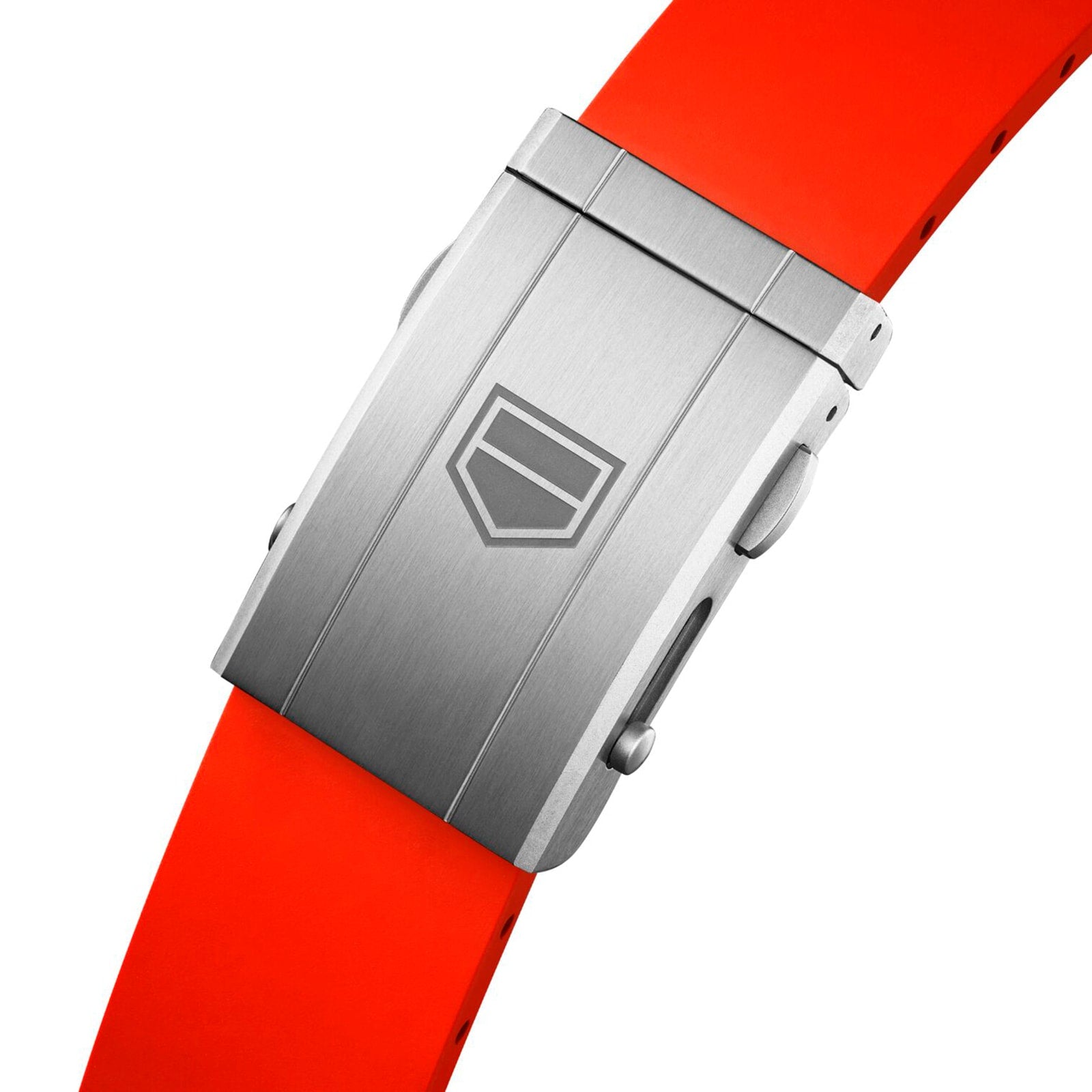 A close-up of the brushed metal clasp engraved with the TAG Heuer logo, attached to a vivid orange strap—part of the Carrera Chronograph Extreme Sport collection.