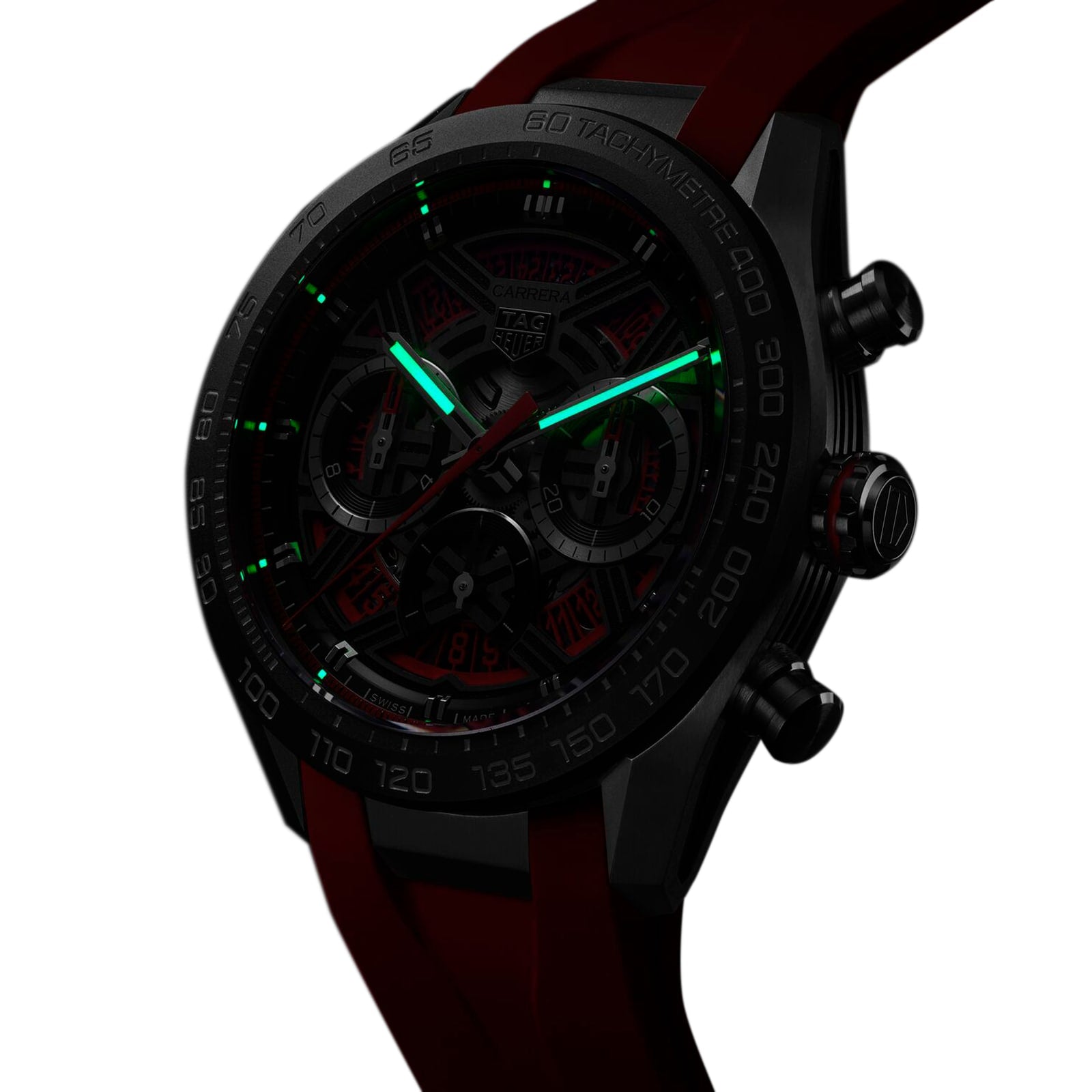 A black TAG Heuer Carrera Chronograph Extreme Sport watch with a red strap and luminous green hour and minute hands, featuring the TH20-00 movement, is photographed against a white background.