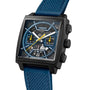 The TAG Heuer Monaco Chronograph features a square face, blue textured strap, black titanium case, open-worked dial with yellow second hand, and two subdials for chronograph functions.