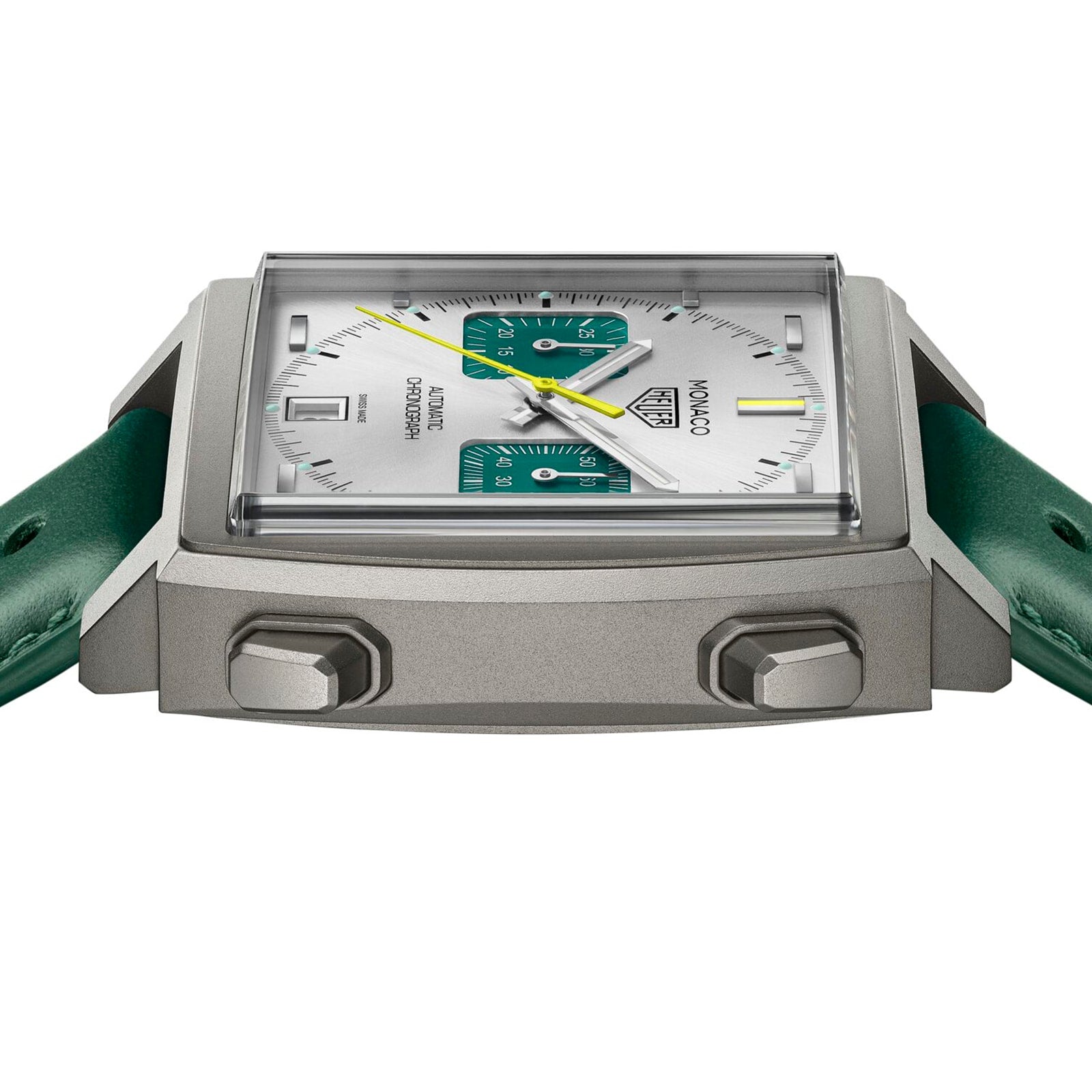 A side view of the TAG Heuer Monaco Chronograph Racing Green watch with a square case, silver dial, Racing Green subdials, yellow second hand, and green leather strap.